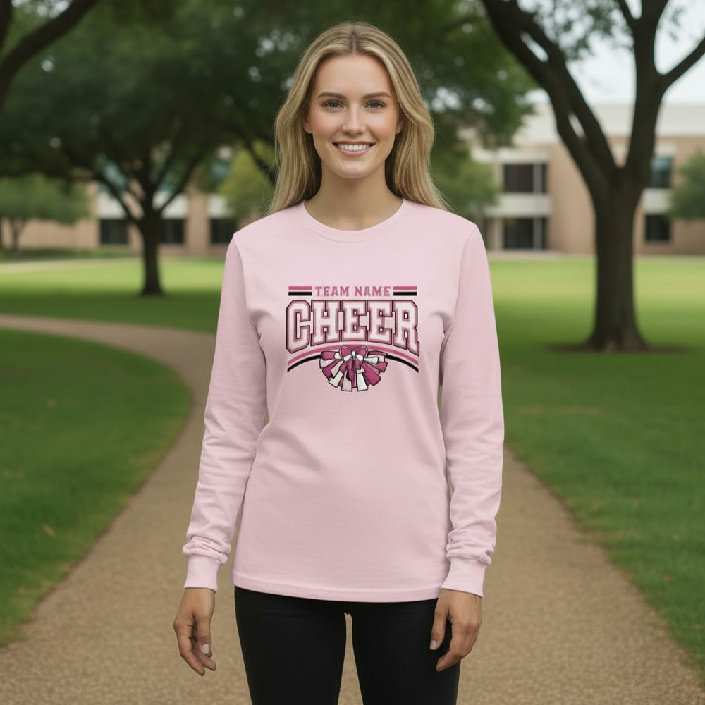 Female model wearing a light pink custom Pink Out cheer Long Sleeve with a personalized team name for breast cancer awareness fundraising.