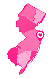 Neon pink glowing map outline of Israel with a heart-shaped location pin marking a city.