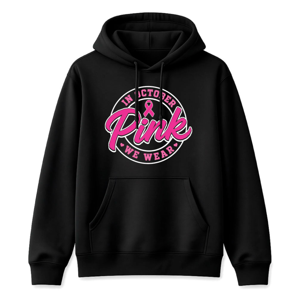 Circular "In October We Wear Pink" breast cancer awareness design featuring a pink ribbon and bold script lettering for custom Pink Out shirts and fundraiser apparel.