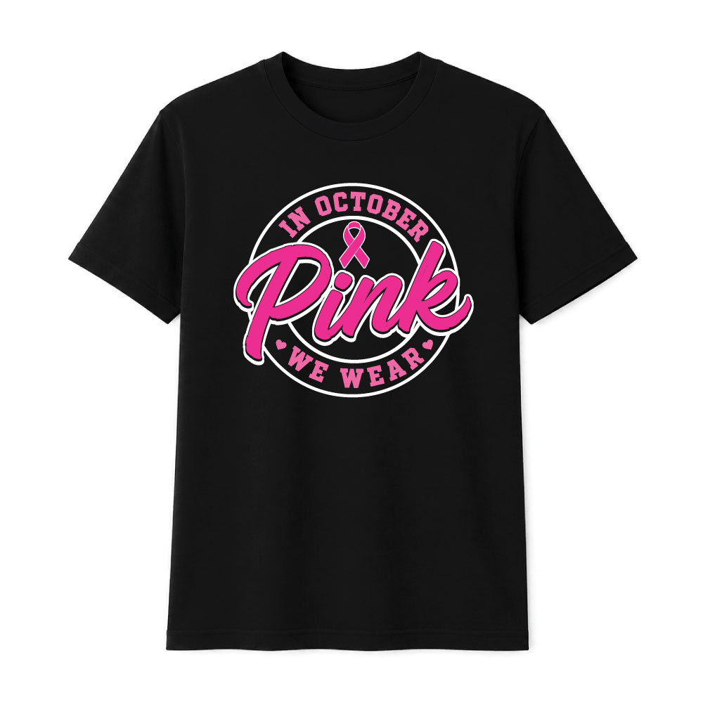 Circular "In October We Wear Pink" breast cancer awareness design featuring a pink ribbon and bold script lettering for custom Pink Out shirts and fundraiser apparel.