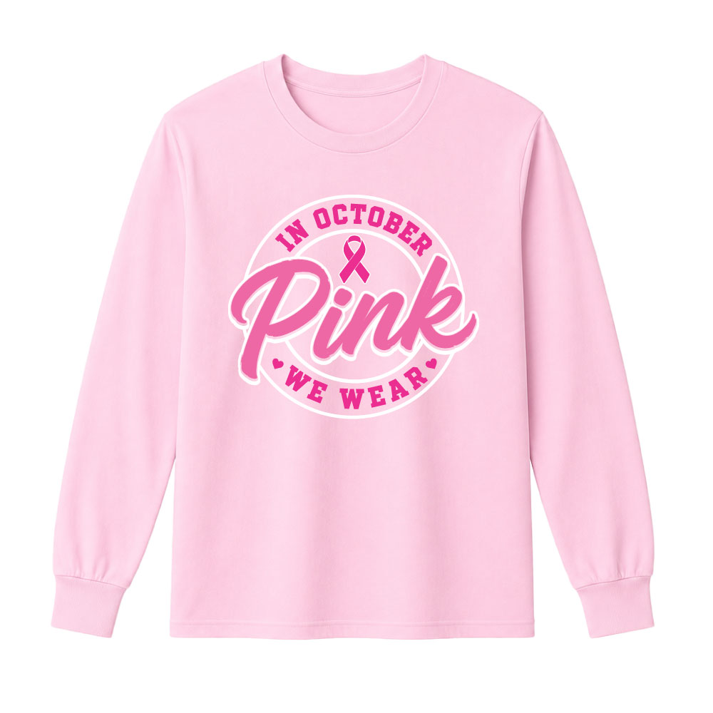 Circular "In October We Wear Pink" breast cancer awareness design featuring a pink ribbon and bold script lettering for custom Pink Out shirts and fundraiser apparel.