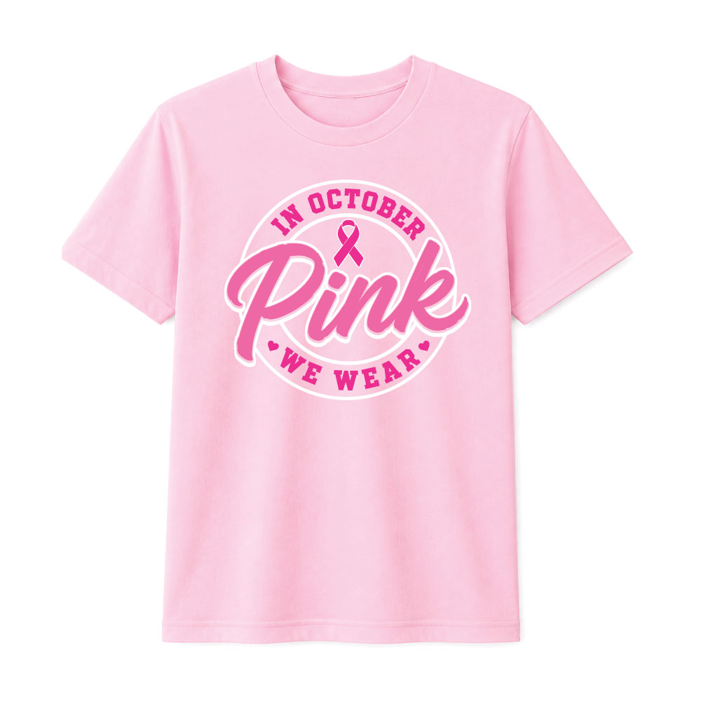 Circular "In October We Wear Pink" breast cancer awareness design featuring a pink ribbon and bold script lettering for custom Pink Out shirts and fundraiser apparel.